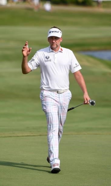 Ian Poulter of England waves while walking up the 18th hole during the third round of the World Golf Championships-FedEx St. Jude Invitational at TPC...