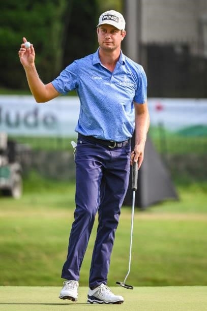 Harris English waves his ball to fans after making a par putt on the 18th hole green during the third round of the World Golf Championships-FedEx St....