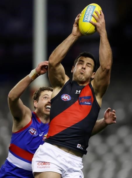 Alec Waterman of the Bombers marks the ball ahead of Zaine Cordy of the Bulldogs during the 2021 AFL Round 21 match between the Western Bulldogs and...