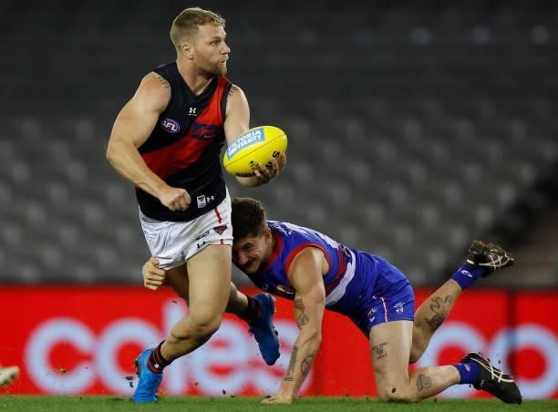 Jake Stringer of the Bombers is tackled by Tom Liberatore of the Bulldogs during the 2021 AFL Round 21 match between the Western Bulldogs and the...
