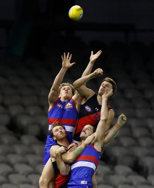 Aaron Naughton of the Bulldogs marks the ball ahead of Jordan Ridley of the Bombers during the 2021 AFL Round 21 match between the Western Bulldogs...
