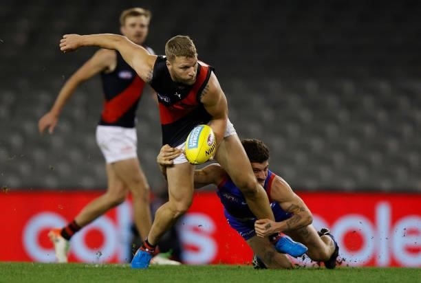 Jake Stringer of the Bombers is tackled by Tom Liberatore of the Bulldogs during the 2021 AFL Round 21 match between the Western Bulldogs and the...