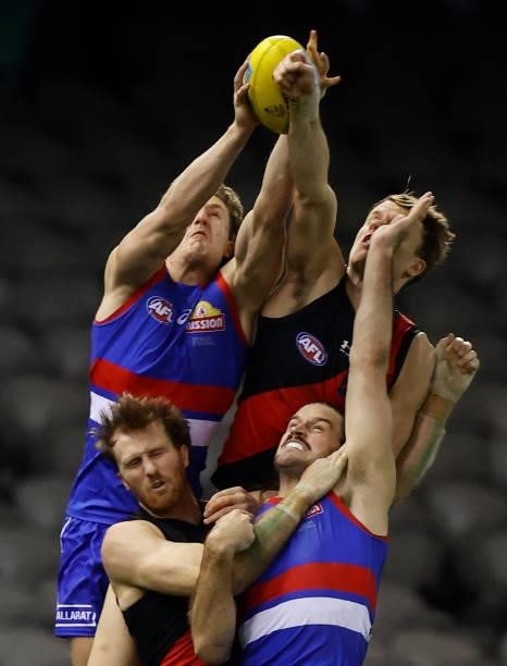 Aaron Naughton of the Bulldogs marks the ball ahead of Jordan Ridley of the Bombers during the 2021 AFL Round 21 match between the Western Bulldogs...