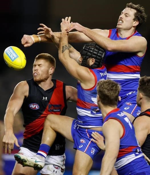 Peter Wright of the Bombers, Caleb Daniel of the Bulldogs and Zaine Cordy of the Bulldogs compete for the ball during the 2021 AFL Round 21 match...