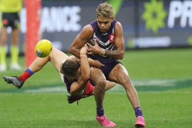 Liam Henry of the Dockers is tackled by Thomas Berry of the Lions during the 2021 AFL Round 21 match between the Fremantle Dockers and the Brisbane...