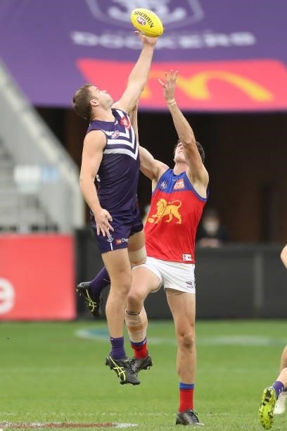 Sean Darcy of the Dockers contests a ruck with Oscar McInerney of the Lions during the 2021 AFL Round 21 match between the Fremantle Dockers and the...