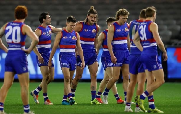 Josh Bruce of the Bulldogs is consoled by teammates during the 2021 AFL Round 21 match between the Western Bulldogs and the Essendon Bombers at...