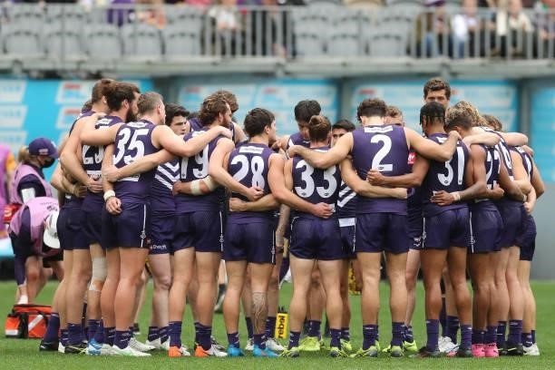 The Dockers form huddle during the 2021 AFL Round 21 match between the Fremantle Dockers and the Brisbane Lions at Optus Stadium on August 8, 2021 in...
