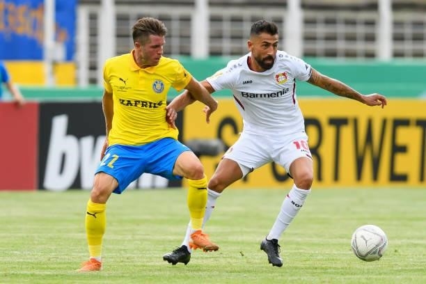 Maik Salewski of 1. FC Lokomotive Leipzig and Kerem Demirbay of Bayer 04 Leverkusen battle for the ball during the DFB Cup first round match between...