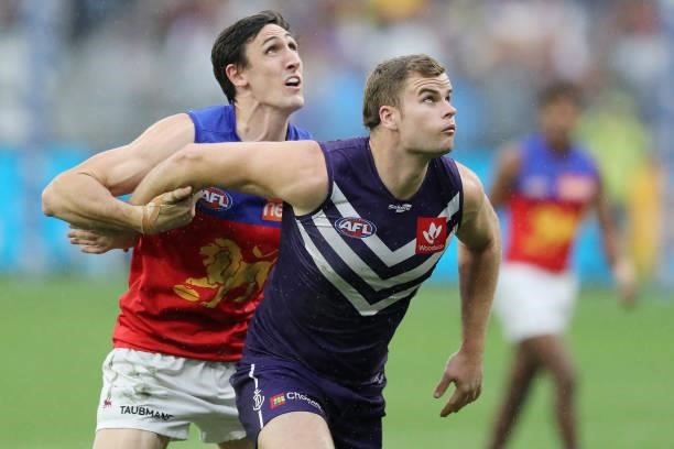 Oscar McInerney of the Lions contests a ruck with Sean Darcy of the Dockers during the 2021 AFL Round 21 match between the Fremantle Dockers and the...