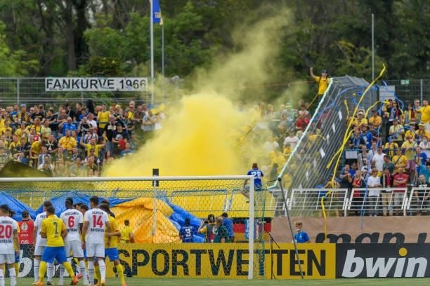 Supporters of 1. FC Lokomotive Leipzig use pyrotechnics during the DFB Cup first round match between 1. FC Lok Leipzig and Bayer Leverkusen at...