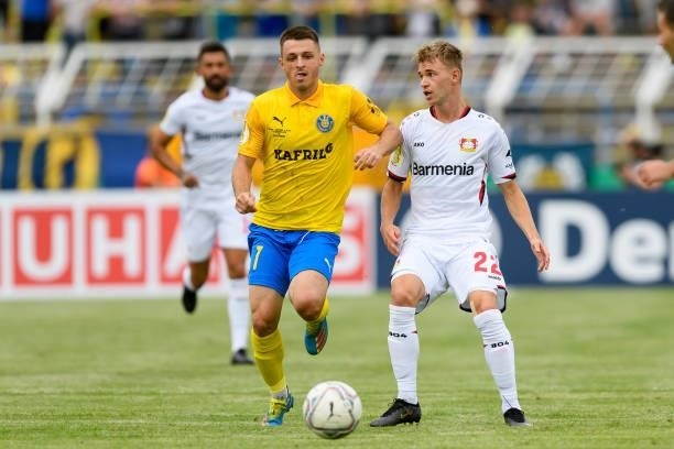 Bogdan Rangelov of 1. FC Lokomotive Leipzig and Daley Sinkgraven of Bayer 04 Leverkusen battle for the ball during the DFB Cup first round match...