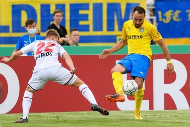 Daley Sinkgraven of Bayer 04 Leverkusen and Robert Berger of 1. FC Lokomotive Leipzig battle for the ball during the DFB Cup first round match...