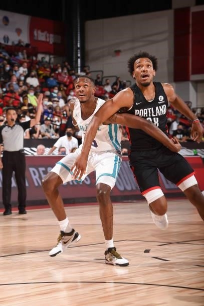 Scottie Lewis of Charlotte Hornets and George King of the Portland Trail Blazers fight for position during the 2021 Las Vegas Summer League on August...