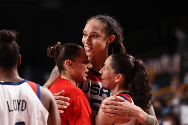 Sue Bird and Diana Taurasi embrace with Brittney Griner of the USA Women's National Team after winning the Gold Medal Game of the 2020 Tokyo Olympics...