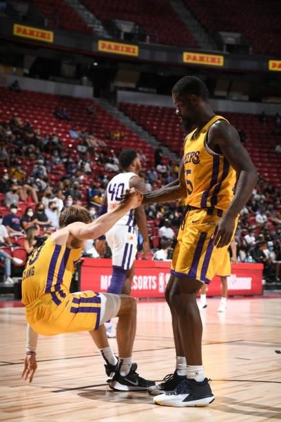 Chaundee Brown Jr. #15 helps up Mac McClung of the Los Angeles Lakers during the 2021 Las Vegas Summer League on August 8, 2021 at the Thomas & Mack...