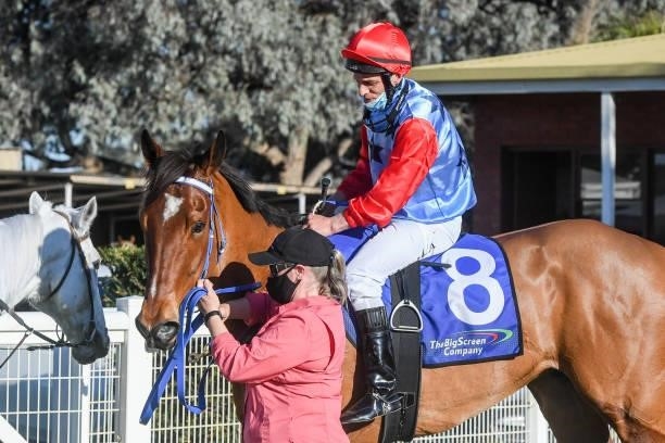 Steven Vella returns to the mounting yard on First Mate after winning the The Gateway BM64 Handicap at Mildura Racecourse on August 09, 2021 in...