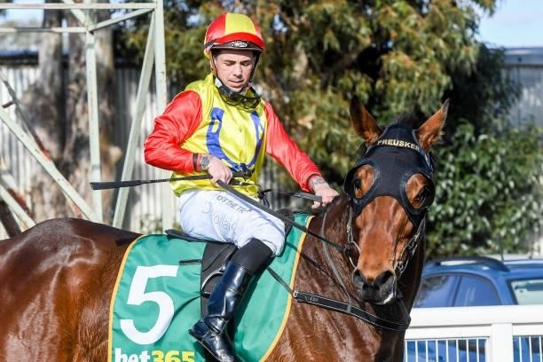 Dean Holland returns to the mounting yard on Lunch Session after winning the bet365 BM58 Handicap at Mildura Racecourse on August 09, 2021 in...