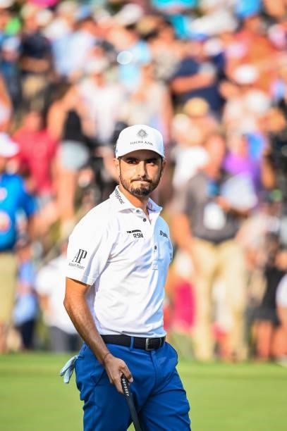 Abraham Ancer of Mexico smiles after making a birdie putt on the 18th hole green during a playoff in the final round of the World Golf...