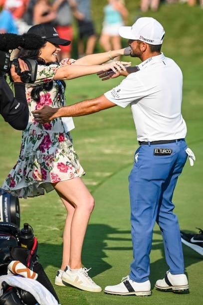 Abraham Ancer of Mexico hugs his girlfriend Nicole Curtright following his playoff victory on the 18th hole green in the final round of the World...