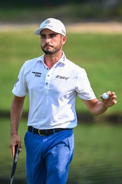 Abraham Ancer of Mexico waves his ball to fans after making a par putt on the 18th hole green in regulation during the final round of the World Golf...