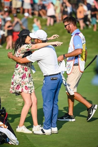Abraham Ancer of Mexico hugs his girlfriend Nicole Curtright following his playoff victory on the 18th hole green in the final round of the World...