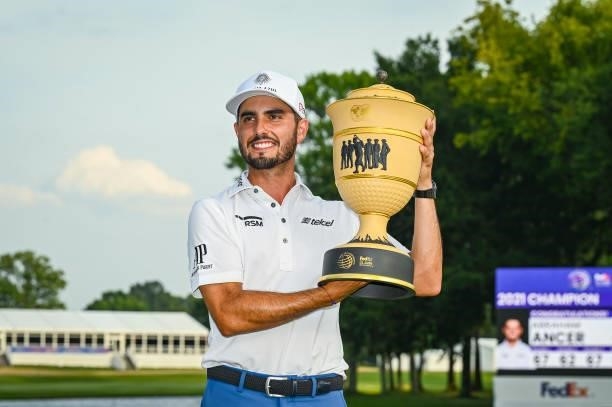 Abraham Ancer of Mexico smiles with the Gary Player Cup trophy following his playoff victory in the final round of the World Golf Championships-FedEx...