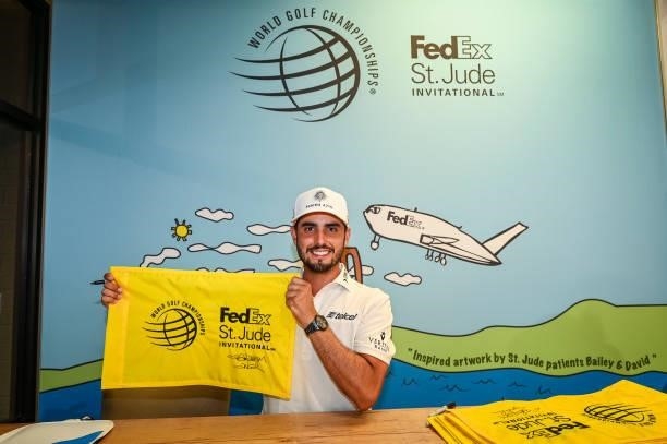 Abraham Ancer of Mexico poses with a signed pin flag following his playoff victory in the final round of the World Golf Championships-FedEx St. Jude...