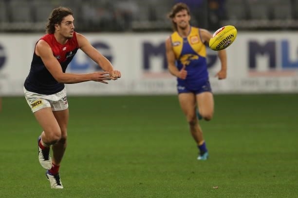 Luke Jackson of the Demons handpasses the ball during the 2021 AFL Round 21 match between the West Coast Eagles and the Melbourne Demons at Optus...