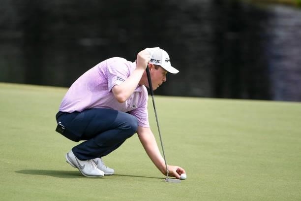 Robert MacIntyre of Scotland lines up his putt at the 18th green during the final round of the World Golf Championships-FedEx St. Jude Invitational...