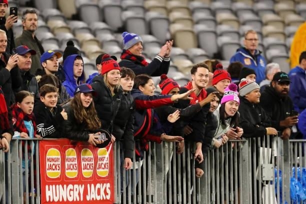 Melbourne fans celebrate the teams win during the 2021 AFL Round 21 match between the West Coast Eagles and the Melbourne Demons at Optus Stadium on...