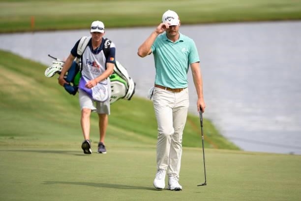 Sam Burns tips his hat at the 18th green during the final round of the World Golf Championships-FedEx St. Jude Invitational at TPC Southwind on...