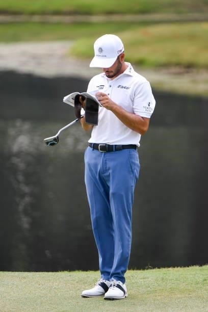 Abraham Ancer of Mexico looks over his yardage book at the ninth green during the final round of the World Golf Championships-FedEx St. Jude...