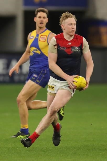 Clayton Oliver of the Demons looks to pass the ball during the 2021 AFL Round 21 match between the West Coast Eagles and the Melbourne Demons at...