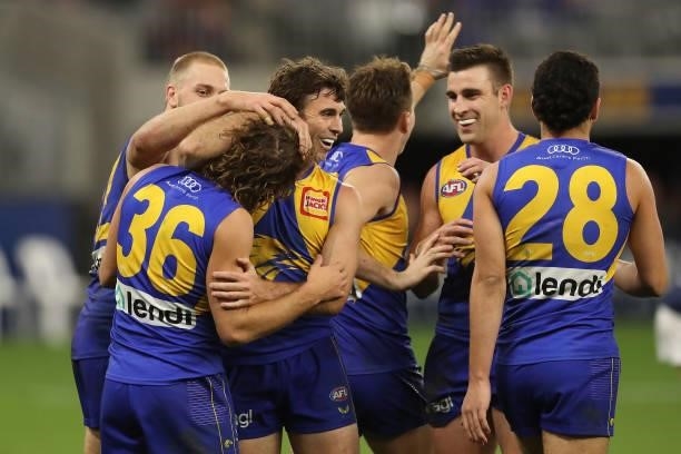Connor West of the Eagles is mobbed by team mates after scoring a goal during the 2021 AFL Round 21 match between the West Coast Eagles and the...