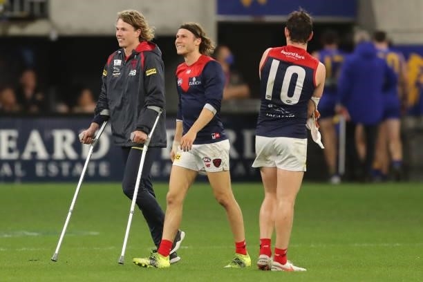 Jayden Hunt of the Demons leaves the field on crutches after the teams win during the 2021 AFL Round 21 match between the West Coast Eagles and the...