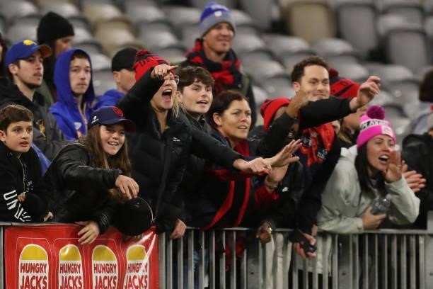 Melbourne fans celebrate after the teams win during the 2021 AFL Round 21 match between the West Coast Eagles and the Melbourne Demons at Optus...