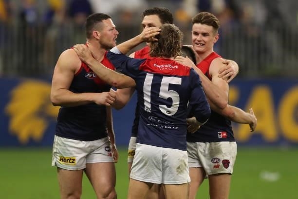 Melbourne celebrate after the teams win during the 2021 AFL Round 21 match between the West Coast Eagles and the Melbourne Demons at Optus Stadium on...