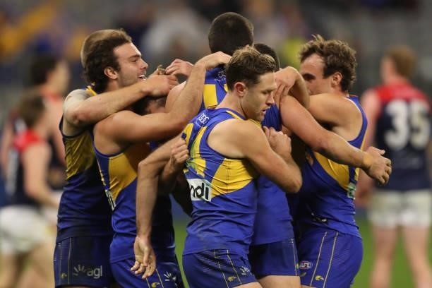 Connor West of the Eagles is mobbed by team mates after scoring a goal during the 2021 AFL Round 21 match between the West Coast Eagles and the...