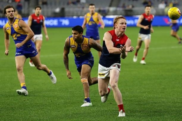 Jake Bowey of the Demons handpasses the ball during the 2021 AFL Round 21 match between the West Coast Eagles and the Melbourne Demons at Optus...