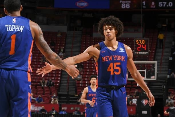 Obi Toppin of the New York Knicks high fives Jericho Sims of the New York Knicks during the 2021 Las Vegas Summer League on August 9, 2021 at the...