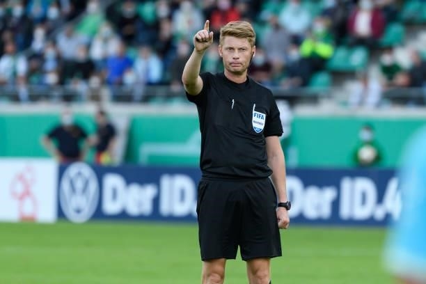 Referee Christian Dingert gestures during the DFB Cup first round match between Preussen Muenster and VfL Wolfsburg at Preussenstadion on August 8,...
