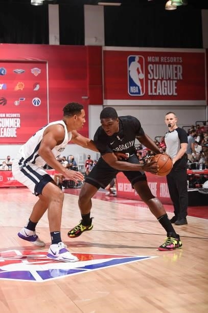 Reggie Perry of the Brooklyn Nets handles the ball as Desmond Bane of the Memphis Grizzlies plays defense during the 2021 Las Vegas Summer League on...