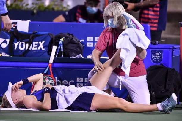 Harriet Dart of Great Britain receives medical attention during her Womens Singles first round match against Leylah Fernandez of Canada on Day One of...