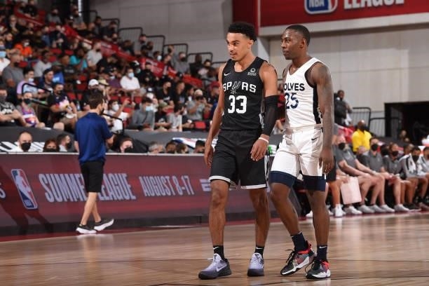 Tre Jones of the San Antonio Spurs and McKinley Wright IV of the Minnesota Timberwolves look on during the 2021 Las Vegas Summer League on August 9,...