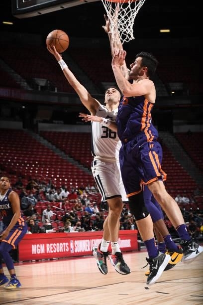 Matt Mooney of the Utah Jazz White drives to the basket during the game against the Phoenix Suns during the 2021 Las Vegas Summer League on August 9,...