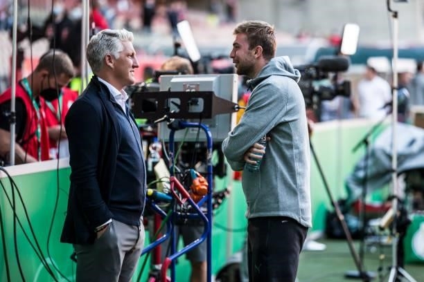 Bastain Schweinsteiger talks to Christoph Kramer of Borussia Moenchengladbach ahead the first Round DFB-Cup match between 1. FC Kaiserslautern and...