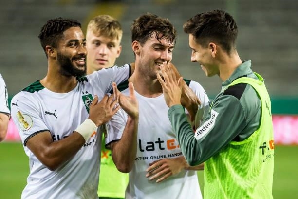 Joe Scally of Borussia Moenchengladbach celebrate with team mates their victory after the first Round DFB-Cup match between 1. FC Kaiserslautern and...