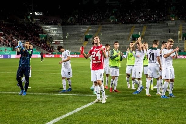 The Team of Borussia Moenchengladbach celebrate their victory with the Fans after the first Round DFB-Cup match between 1. FC Kaiserslautern and...