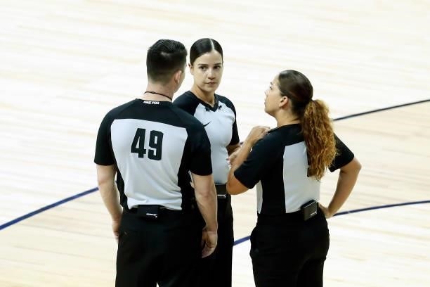 Referee Cameron Gelinas talks with referee Blanca Burns and referee Kristyne Esparza during the 2021 Las Vegas Summer League on August 9, 2021 at the...